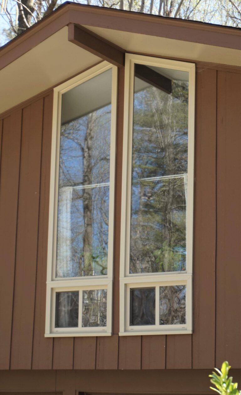 Custom-built single hung vinyl windows from the 900 series, featuring energy-efficient glass and durable frames, installed in a modern home setting with natural reflections.