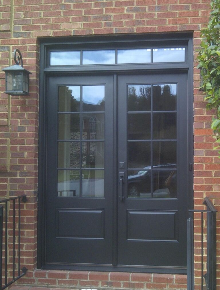 Exterior double doors with glass panels, black finish, and brick entryway, showcasing quality craftsmanship and design for Atlanta homes.