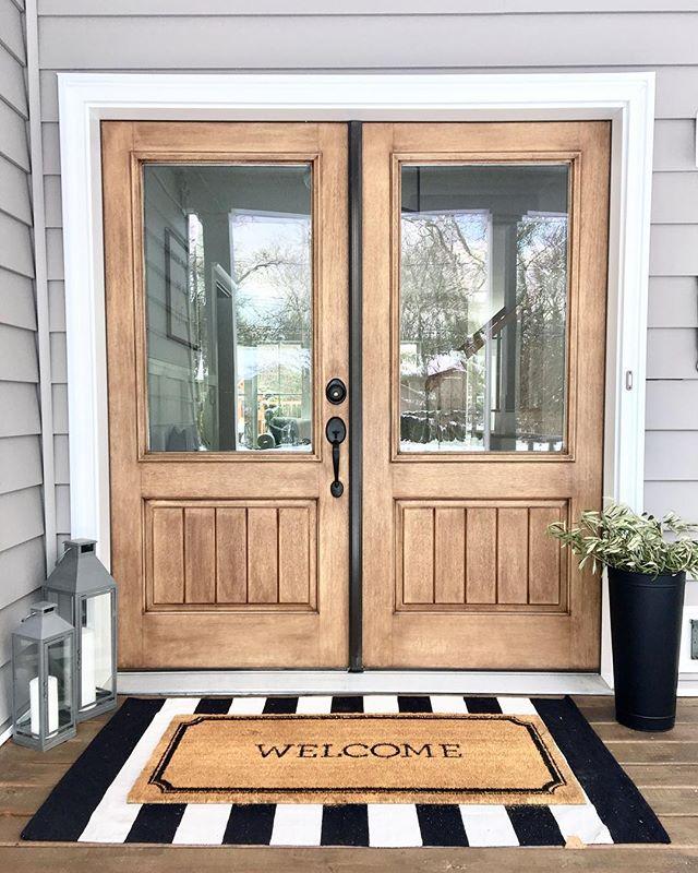 Classic craft double light oak exterior doors with welcome mat, showcasing local craftsmanship and inviting entrance for homes in Georgia.
