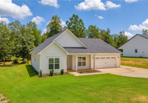 Single-family home exterior with vinyl windows, manicured lawn, and driveway, showcasing a modern design ideal for property management and multifamily projects in Atlanta.