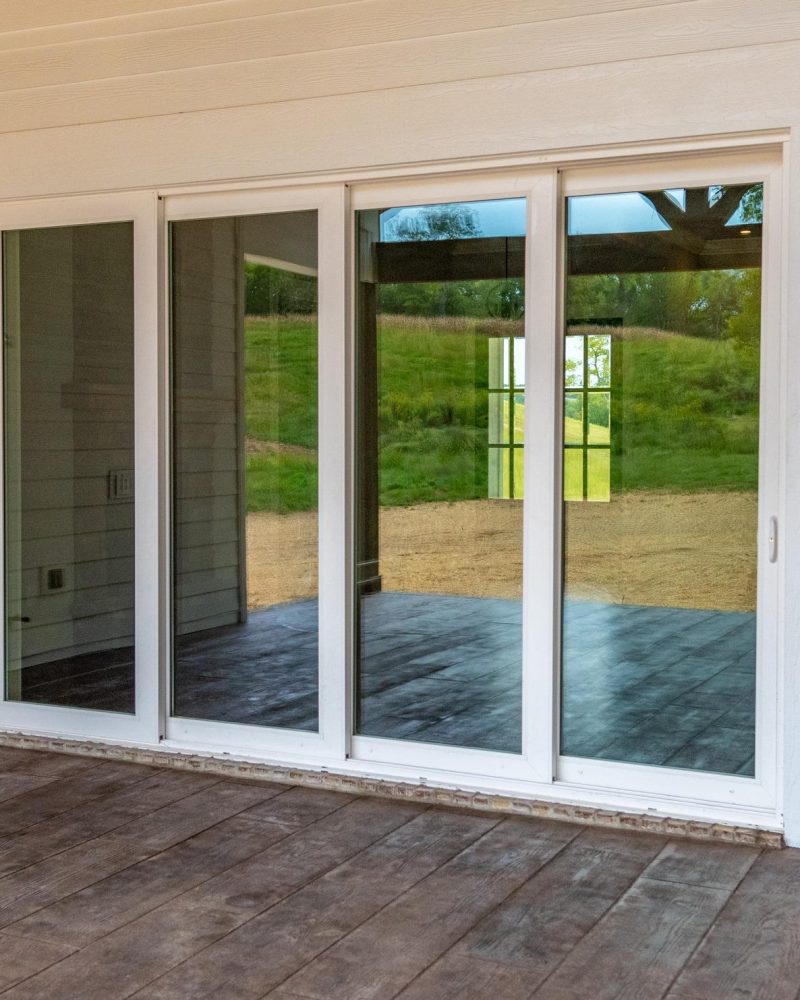 Vinyl sliding doors showcasing a bright and open design, reflecting energy efficiency and modern style, set against a natural backdrop.