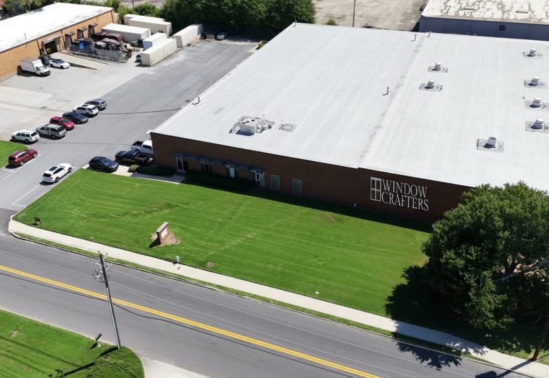 Aerial view of the Window Crafters facility in Tucker, Georgia, showcasing the building's exterior and surrounding green lawn, highlighting local manufacturing and service offerings.